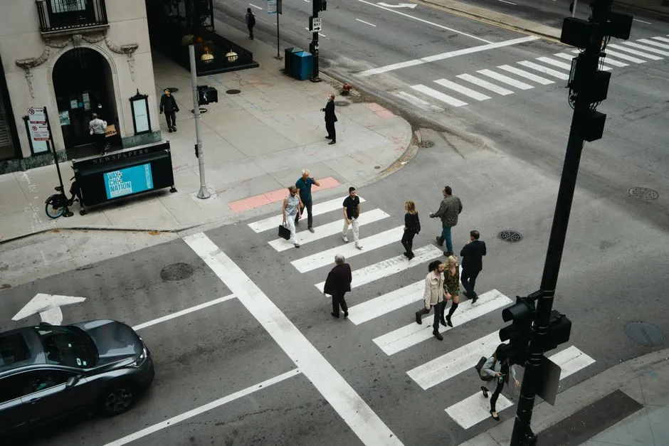 Pedestrians crossing a marked crosswalk on a city street