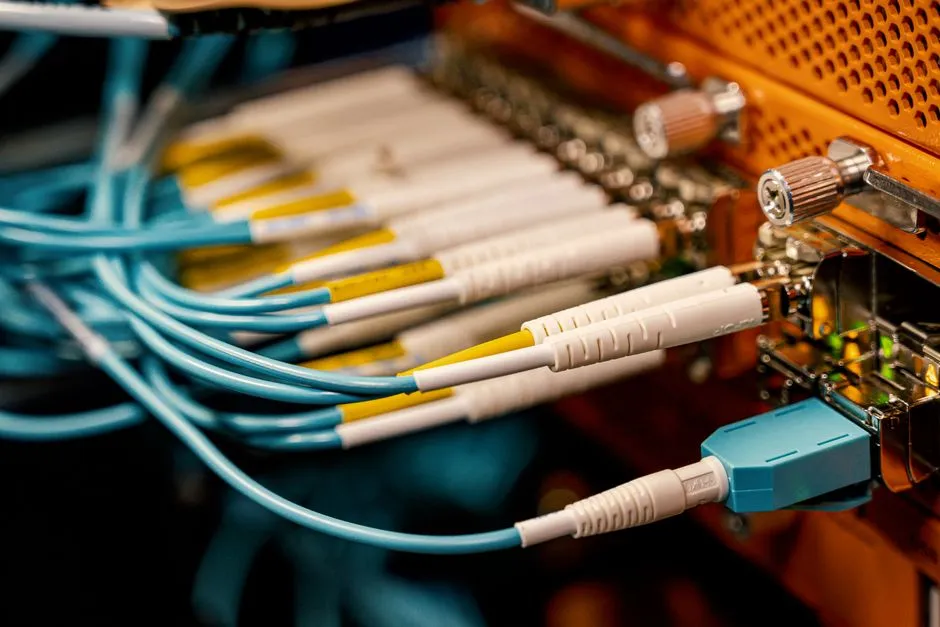 Fiber optic switch equipment with bright connector cables in a network cabinet