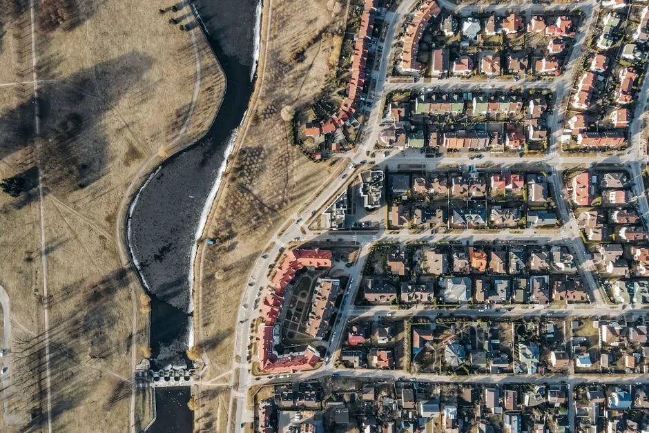 Aerial view of a residential housing development with rows of similar houses