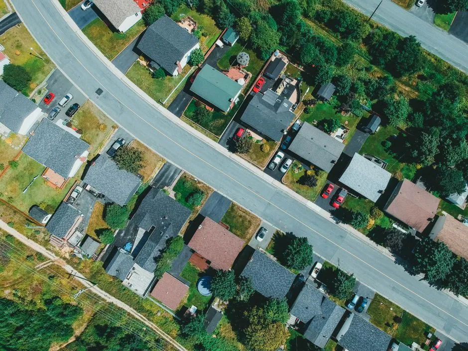 Aerial view of tightly packed suburban houses along curved streets